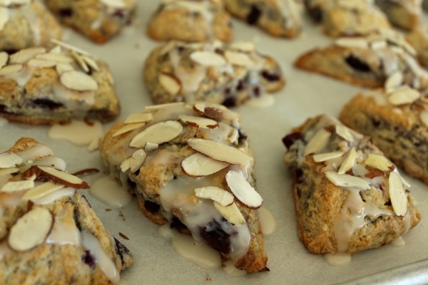 a baking sheet of scones topped with sliced almonds