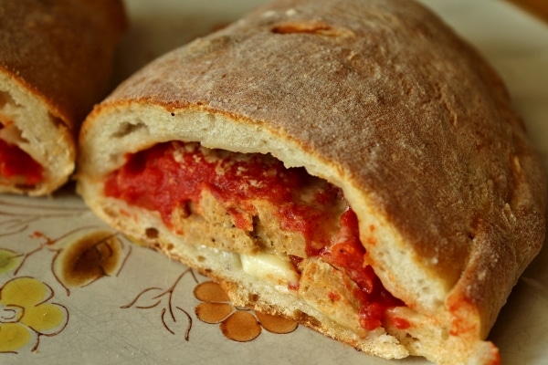 A close up of a cross section of a meatball calzone