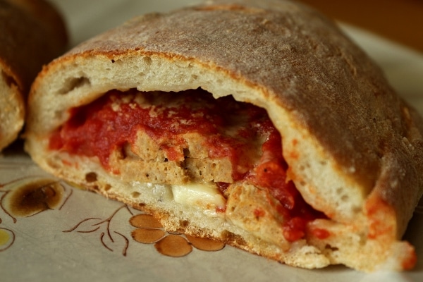 A close up of a cross section of a meatball calzone