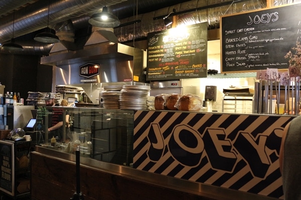 a food stall with a blackboard menu