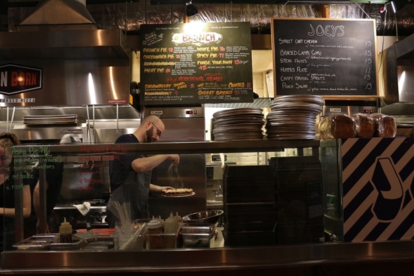 a person cooking inside a food stall