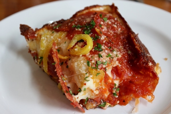 A close up of a slice of pizza on a plate