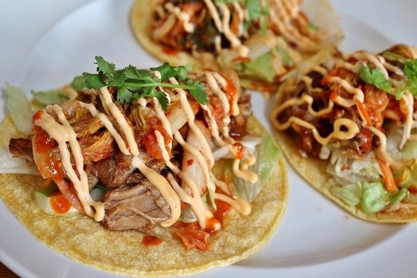 3 kimchi pork tacos on a plate