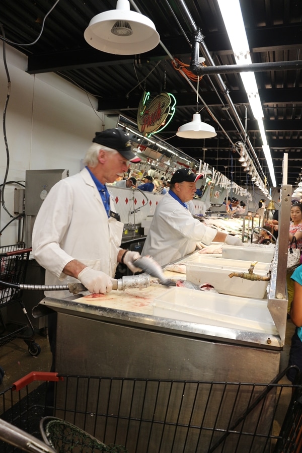 A man cleaning fish in a supermarket