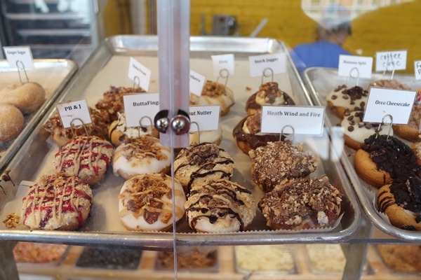 a variety of small donuts for sale in a shop
