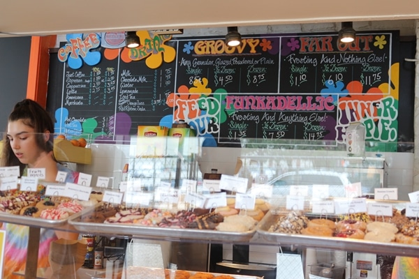 a donut shop with a colorful blackboard menu