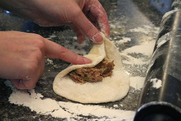 a closeup of hands assembling a bun