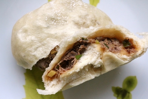 A close up of cross section of a pork bun