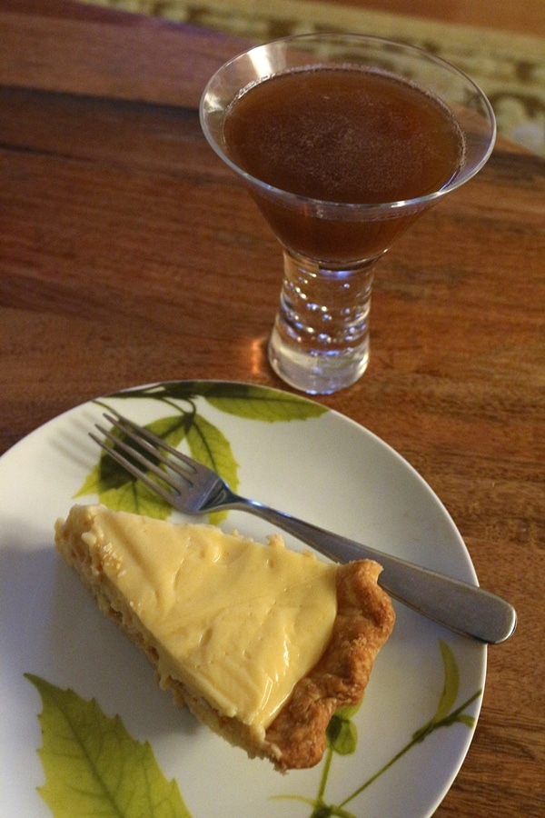 a slice of pie and a cocktail in a glass