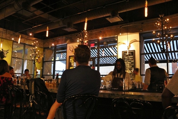 people sitting at the bar in a restaurant