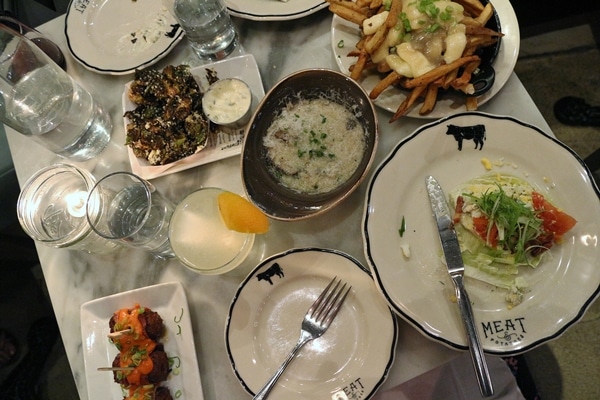 overhead view of a table in a restaurant covered in plates of food