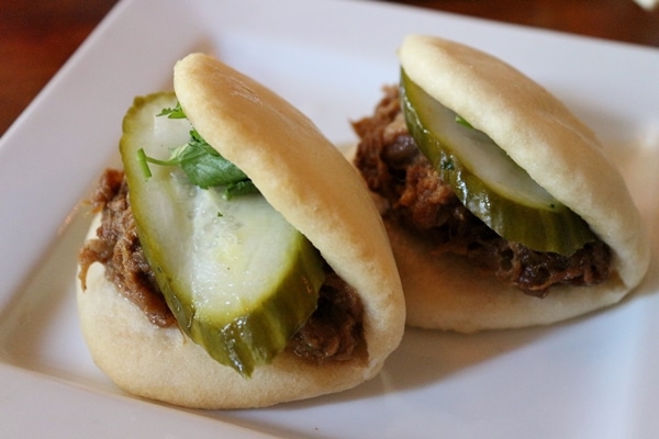 pork buns on a white plate