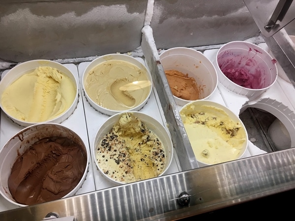 a display of tubs of various kinds of ice cream