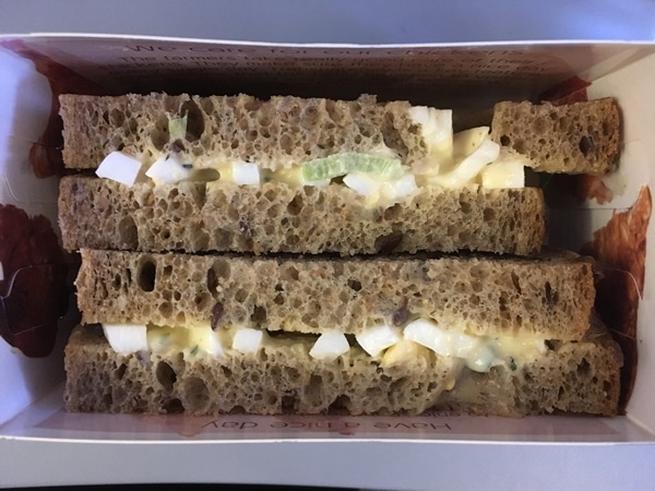 closeup of an egg salad sandwich in a box