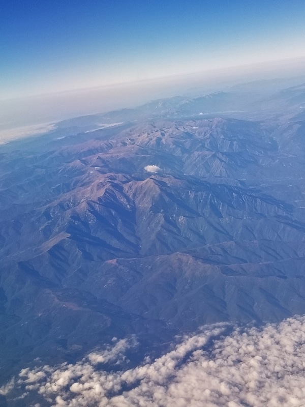 A view of a mountain from an airplane window