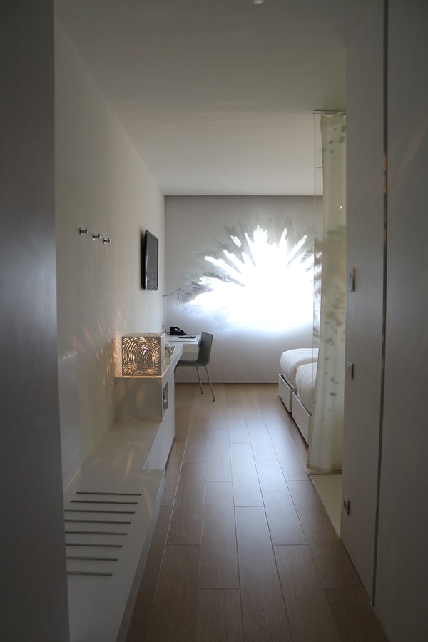 a hotel room with a palm shaped window