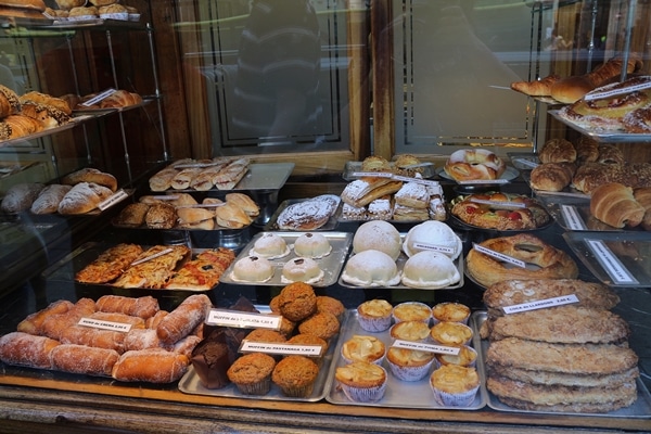 A glass display case with many different types of desserts