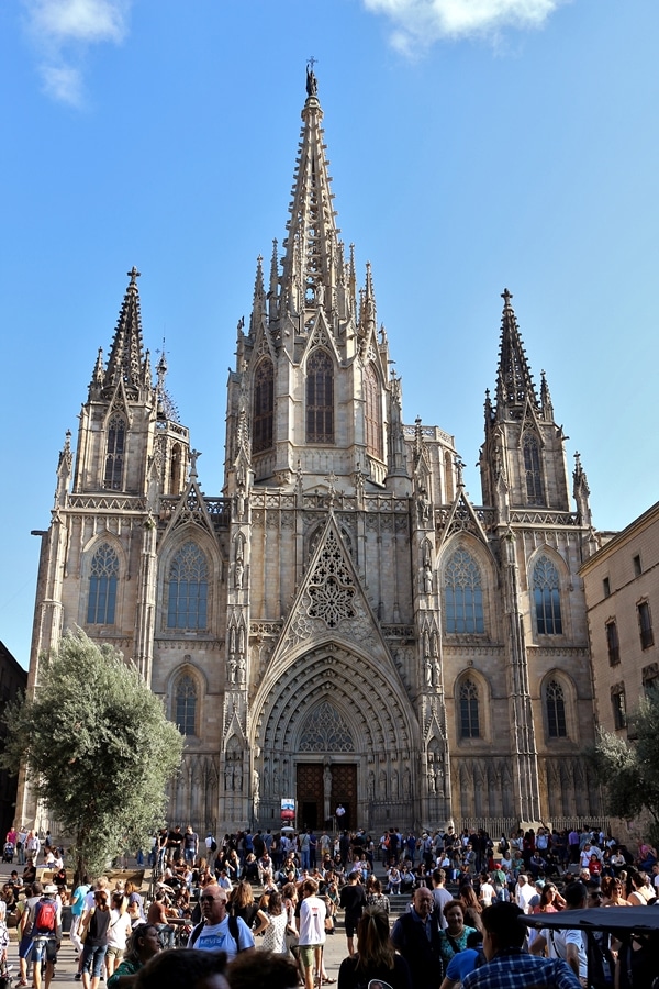 A group of people standing in front of Barcelona Cathedral