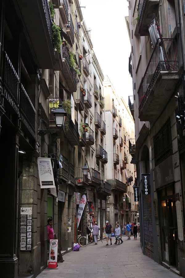 A narrow city street with people walking