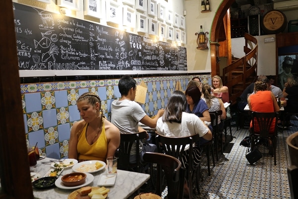 people sitting inside a small restaurant