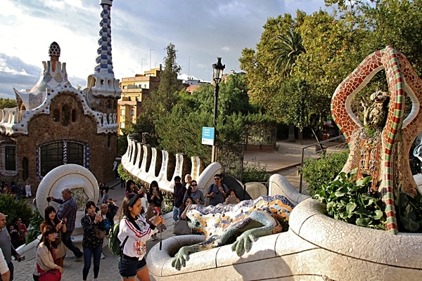 A group of people taking pictures of a statue