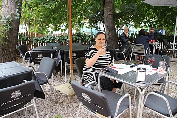 A person sitting at a table outside