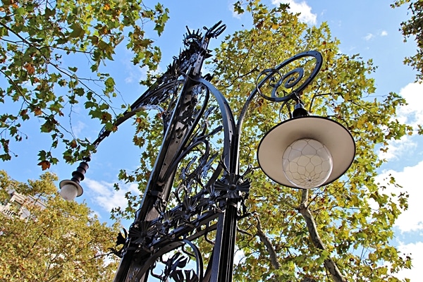 closeup of a fancy street light beneath some trees