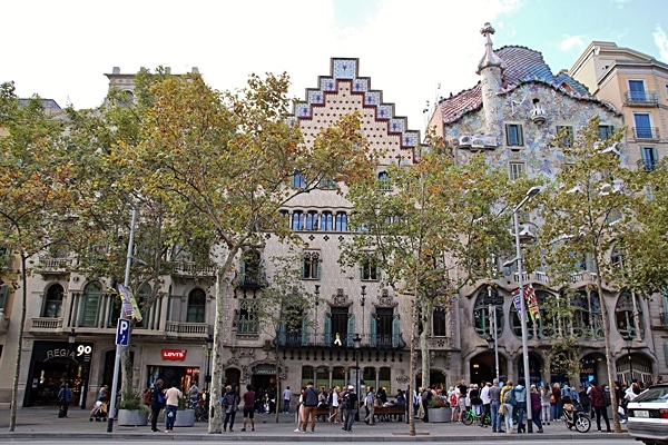A group of people walking in front of Casa Batlló