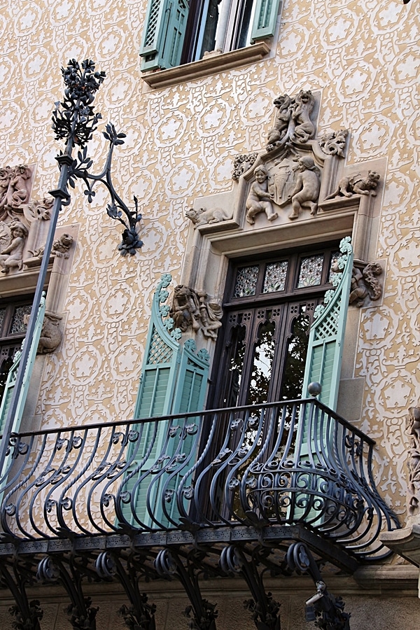 closeup of a carved doorway on a building leading out to a balcony