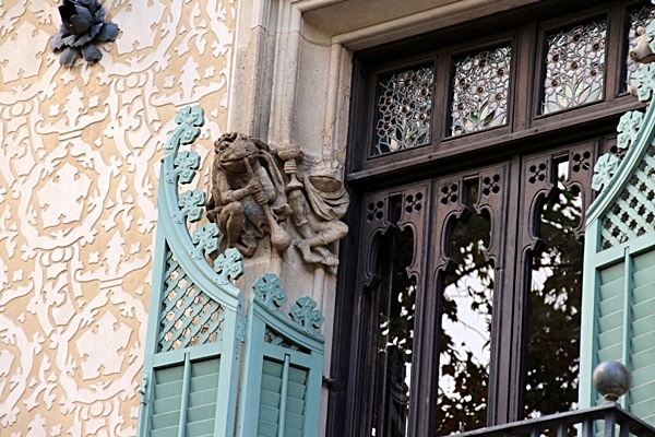 closeup of a musical frog carving next to a doorway