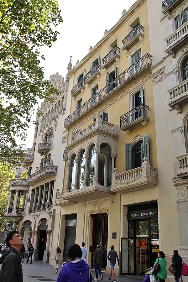 A group of people walking in front of a building