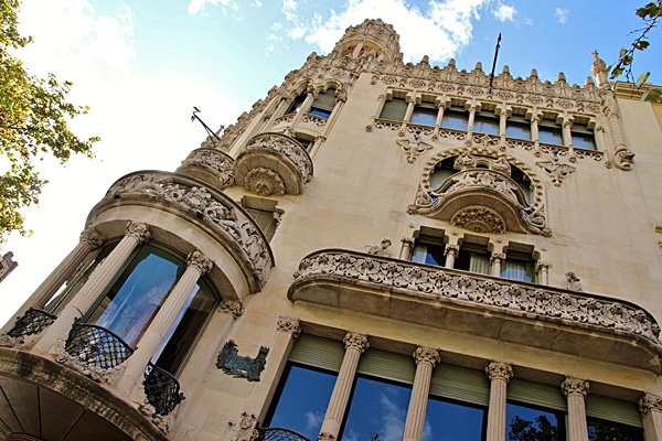 view looking up at an ornately carved stone building facade