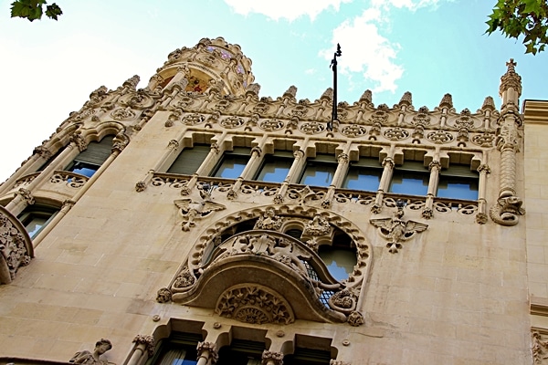 looking up at a building with stone carvings