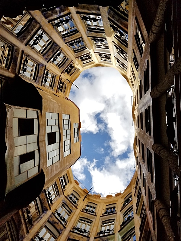 view looking up at the sky from inside the courtyard of a building