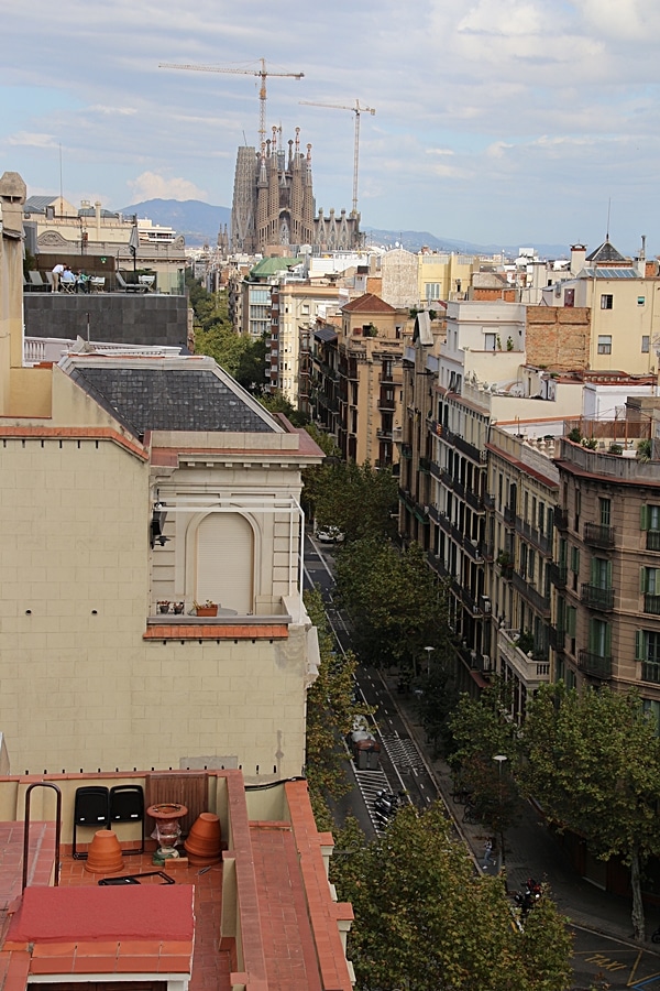 rooftop view of a Barcelona street with Sagrada Familia in the distance