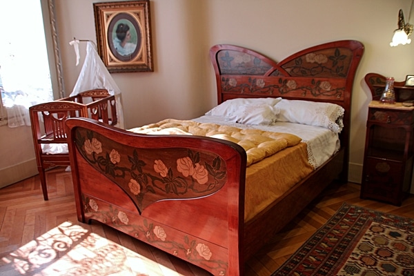 A bedroom with a bed and a crib