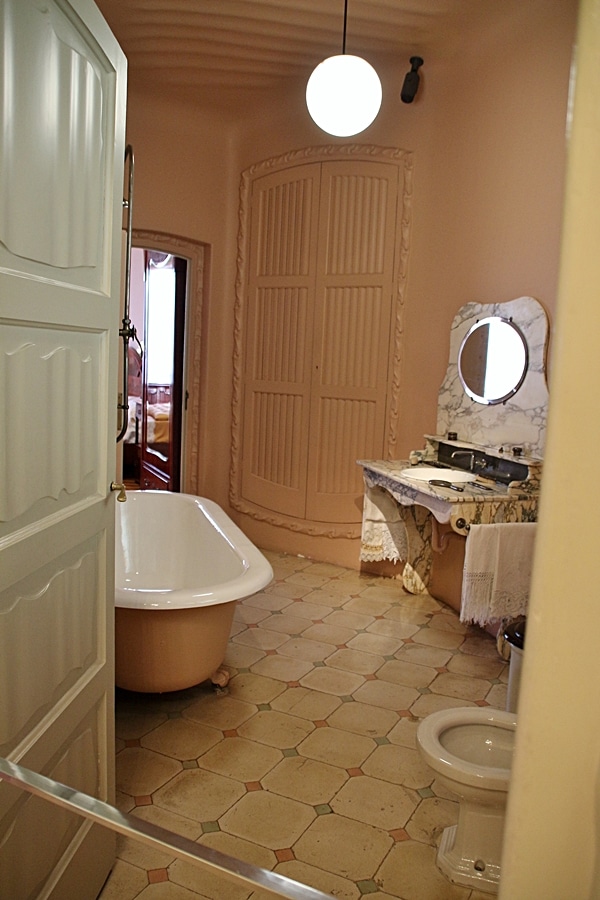 a bathroom with a tub, a sink, and mirror