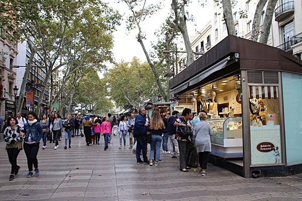 A group of people walking down a street