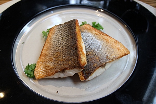 2 fillets of seared fish on a plate