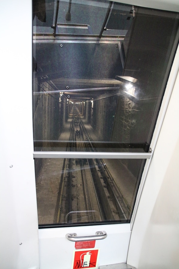 view of train tracks in a dark tunnel