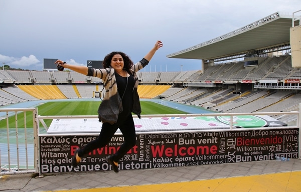 a woman jumping inside an Olympic stadium