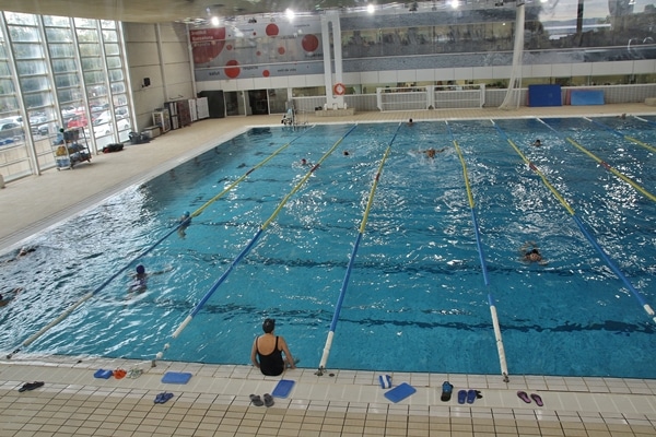A group of people in an indoor swimming pool
