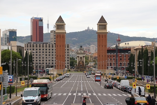 A view of a city street filled with traffic surrounded by tall buildings