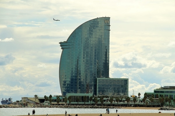 closeup of a glass-covered hotel building on the beach