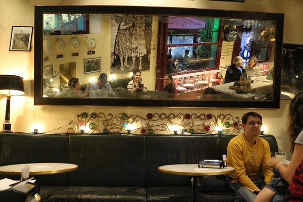 reflection of diners in a large mirror in a restaurant
