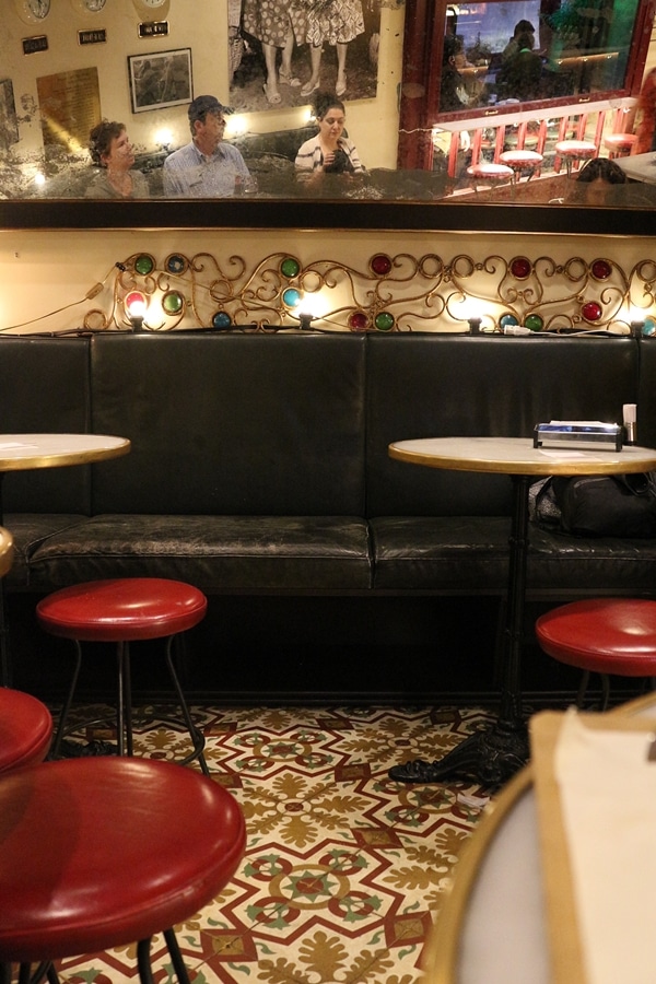 funky colorful restaurant interior with red chairs and tile floors