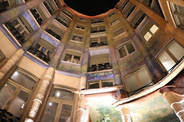 view looking up at a curved opening in a building at night