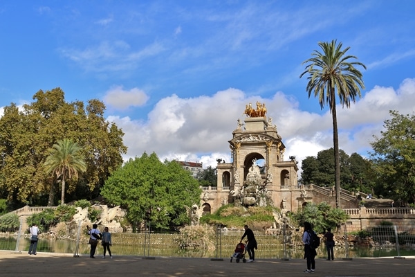 wide view of a fountain and trees inside a park