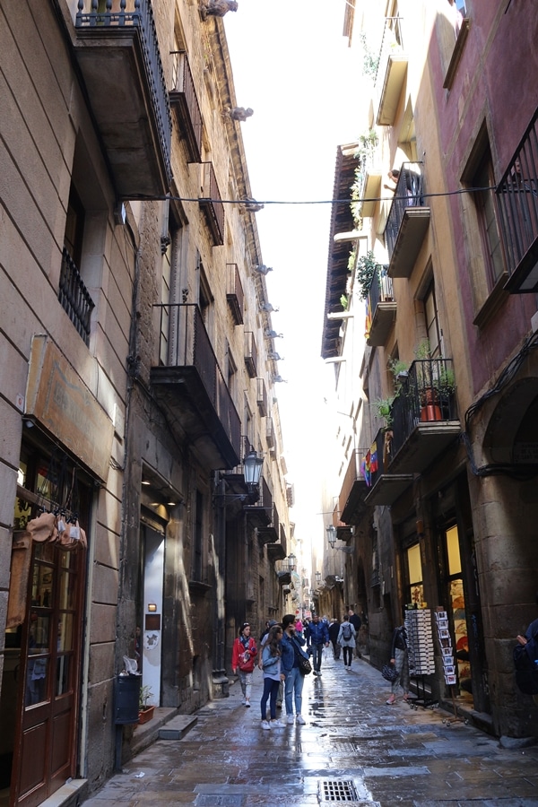 A group of people walking down a narrow street