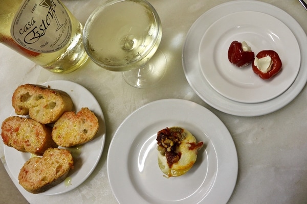 overhead view of small Spanish tapas on white plates